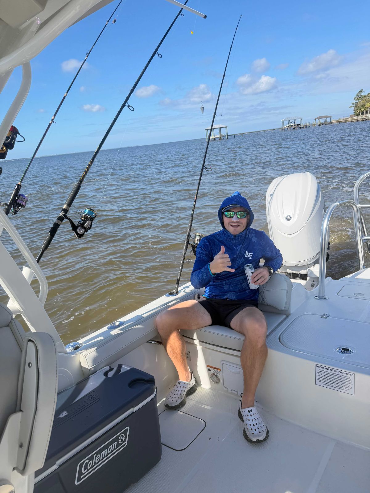 Friends chatting on boat amid blue ocean