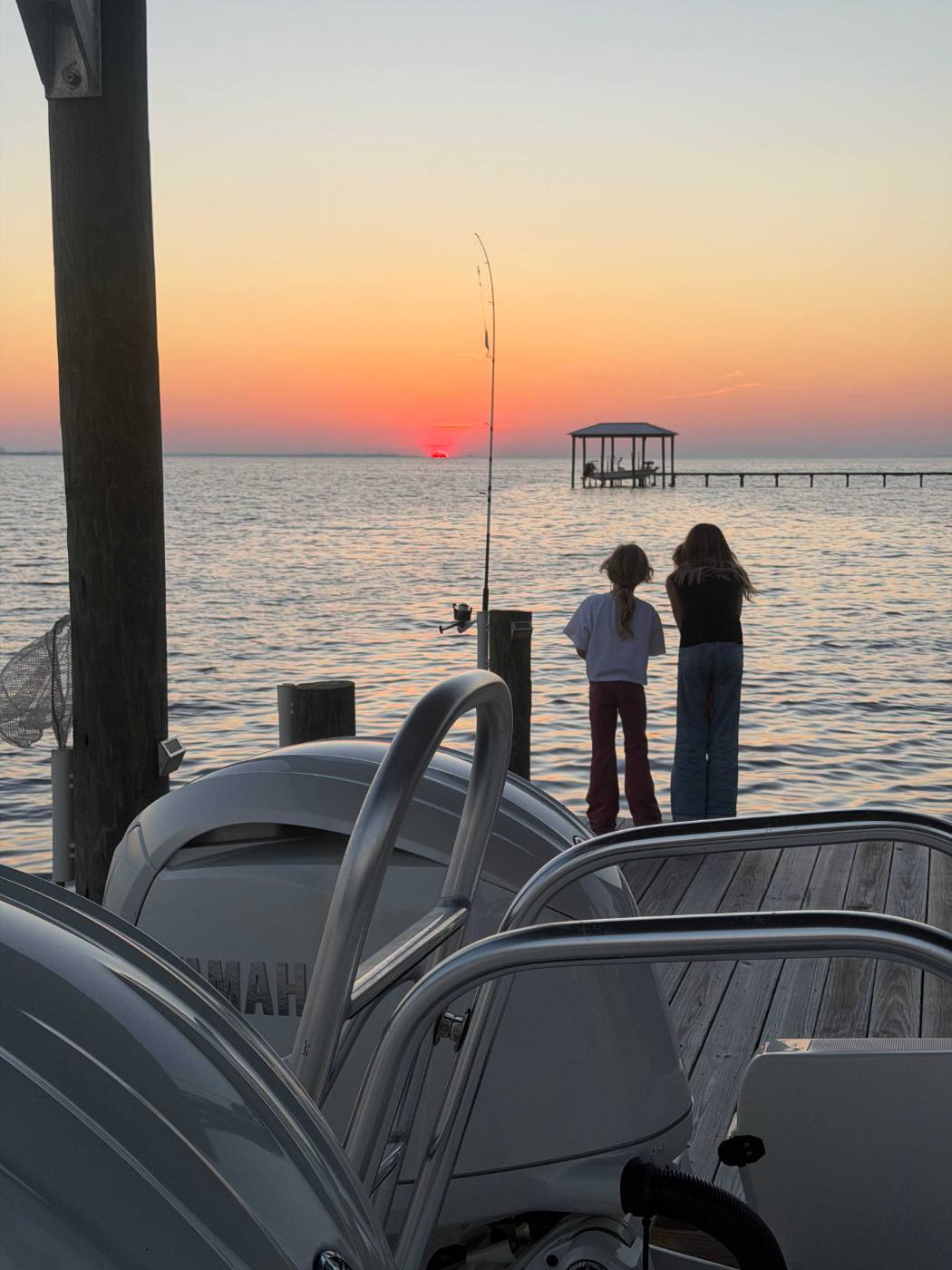 Family enjoying night boat ride with colorful lights