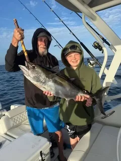 Father and son with an amberjack on a nearshore Gulf fishing excursion