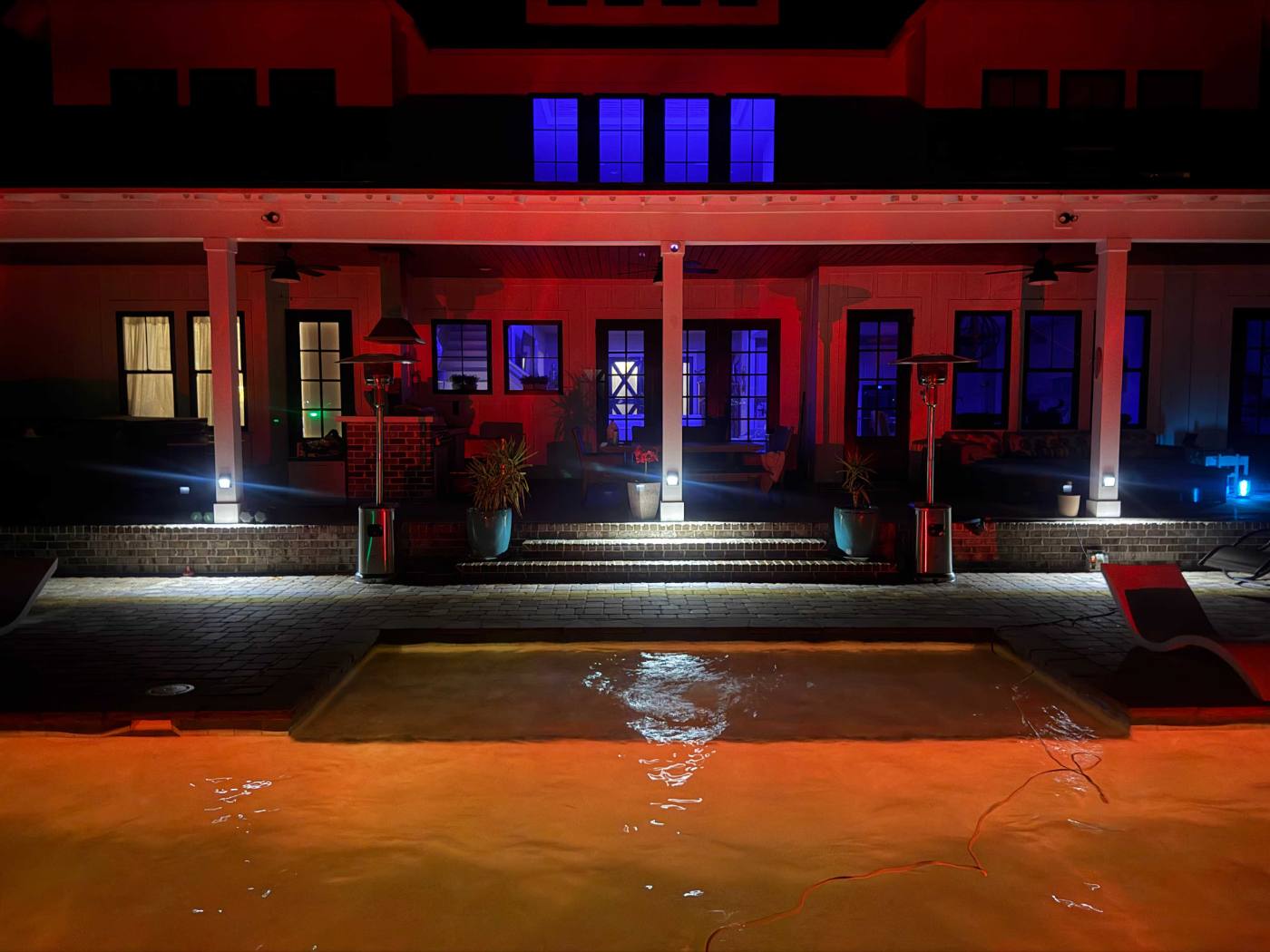 Waterfront dock set with lanterns and florals at sunset