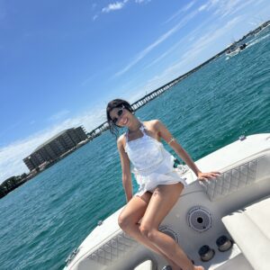 Woman relaxing on boat in sunny turquoise ocean